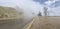 Close up of wet road in fog in mountainous terrain. Asphalt road after rain in foggy and cloudy weather.