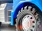 Close-up of a wheel from a blue children`s toy car. Closeup of children`s toys and goods