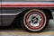 Close up of wheel disk and the side of a vintage automobile