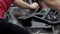 Close-up of wheel of an exercise bike behind which a woman trains in gym.