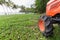 Close up of a wheel of a small tractor on the grass.