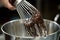 close-up of whisk, mixing chocolate to ensure smooth consistency