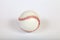 Close-up on a white baseball ball stitched with red thick thread made of genuine leather for the American team game on a white