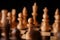 Close up of white and black chess pieces on board. Selective focus on first move of white pawn on chessboard. Concept of