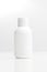 Close up of a white bottle on white background. cosmetic mock up. branding identity mockup concept