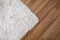 Close-up white carpet on laminate wood floor in living room, interior decoration