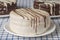 Close up of an white chocolate alfajor, typical candy in Argentina, on a checkered tablecloth