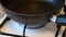 Close Up of White Cooking Stove,Gas on, Black Frying Pan Put on Burner