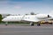 Close-up of white corporate business jet at the airport apron