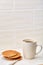 Close-up white cup of coffee with chocolate chip cookies on white background, top view