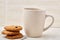 Close-up white cup of coffee with chocolate chip cookies on white background, top view