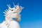 Close up of White dragons china sculpture on blue sky background with copy space