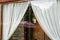 Close-up of white draped curtains in a building window