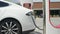 CLOSE UP: White electric car recharging batteries fast at Tesla Supercharger
