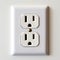 A close up of a white electrical outlet on a wall.