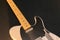 Close up of a white Fender Telecaster electric guitar