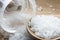 Close-up of white granulated salt isolated on wooden background