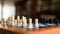 Close up white knight chess piece standing on the chessboard amid pawns and the others on the chessboard. Game on for challenge