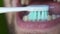 Close up of white man brushing his teeth with an electric toothbrush. Man`s open mouth as he brushes his teeth.
