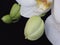 Close up of a White Orchid Bunch and Green Orchid Buds on Black Background. Phalaenopsis known as moth.