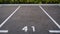 Close-up of a white paint number marking in a parking lot. Empty parking lot, Parking lot with white mark, Open parking in public