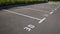 Close-up of a white paint number marking in a parking lot. Empty parking lot, Parking lot with white mark, Open parking in public