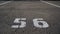 Close-up of a white paint number marking in a parking lot. Empty parking lot, Parking lot with white mark, Open parking in public