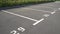 Close-up of a white paint number marking in a parking lot. Empty parking lot, Parking lot with white mark, Open parking in public