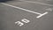 Close-up of a white paint number marking in a parking lot. Empty parking lot, Parking lot with white mark, Open parking in public