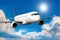 Close-up of white passenger airliner flies in the air above scenic clouds