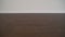 Close up of white plastic baseboards on dark oak wood flooring. The new apartment has black laminate and white basement. new and