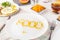 Close up white plate with Food word lettering by vitamin pills on the served wooden table with breakfast meal. Pill instead of foo