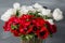 Close-up of a white and red poppies anemones in vase. Many flowers - gray background. winter flower