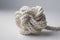 Close up of a white rope knot on a light background