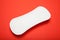 Close-up, white sanitary pad on red background