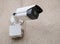 Close up with a white security surveillance camera. CCTV camera on a wall