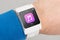 Close up white smart watch with music app icon