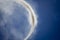 Close up of white smoke forming small tornado  against blue sky