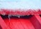 Close up of White Snow Melting into Crystals and Water over Red Roof - Snow Fall in Winter in Himalayas, Uttarakhand, India