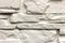 Close-up of white solid limestone wall or stone fence. Abstract copy space background, Bricklaying, construction and masonry