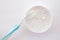 Close-up white tooth powder in an open jar and toothbrush with blue pen on white background. Home Whitening and Hygiene