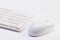 Close up of white wireless keyboard and wired mouse