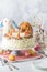 Close up of a whole carrot cake surrounded by Easter decorations ready for celebrating.