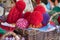 Close up of wicker backet full of knitted wool hats. Christmas fair outdoors