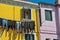 Close-up of windows on colorful walls and clothes hanging on sunny day in Burano.
