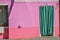 Close-up of windows on colorful walls and door with cloth in Burano.