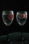 Close up. Wine Glasses filled with Sparkling Drink. Strawberries float in the sizzling liquid. Isolated on black background.