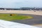 Close Up of Wing of Airplane on Blur Runway at the Airport