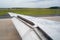 Close Up of a Wing of an Airplane with Flaps Up during the Taxiing on the Runway