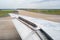 Close Up of a Wing of an Airplane with Flaps Up during the Taxiing on the Runway